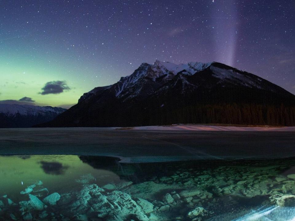 Not only is Lake Minnewanka located far away enough from city light pollution, but the scenic spot also features a gorgeous mountain and lake view to feature in night sky photography. (Paul Zizka - image credit)