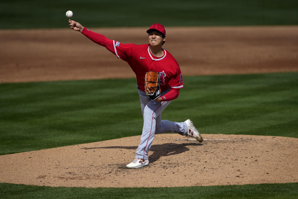 Los Angeles Angels starting pitcher Shohei Ohtani (17) throws against the Oakland Athletics during the third inning of a spring training baseball game, Tuesday, Feb. 28, 2023, in Mesa, Ariz. (AP Photo/Matt York)