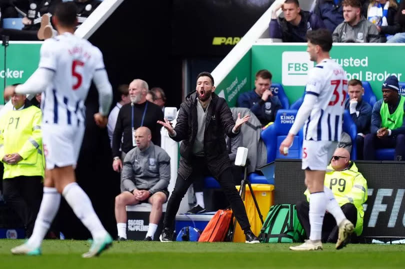 West Brom manager Carlos Corberan shouts instructions at his team from the touchline at Leicester City's King Power Stadium