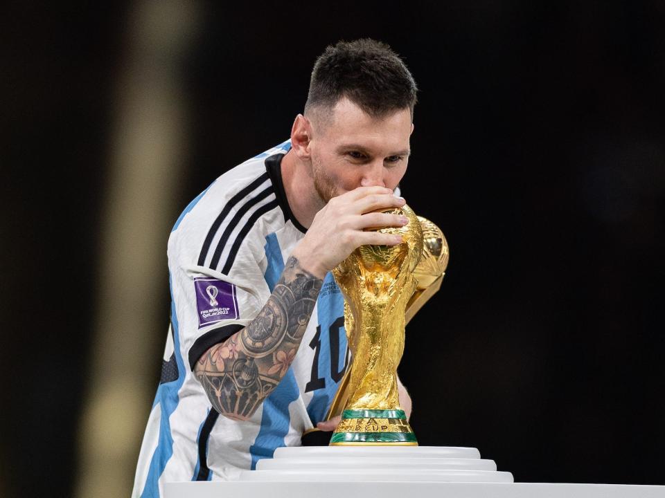 Lionel Messi of Argentina kisses the FIFA World Cup trophy as he collects the Golden Ball award following the FIFA World Cup Qatar 2022 Final match between Argentina and France at Lusail Stadium on December 18, 2022 in Lusail City, Qatar.