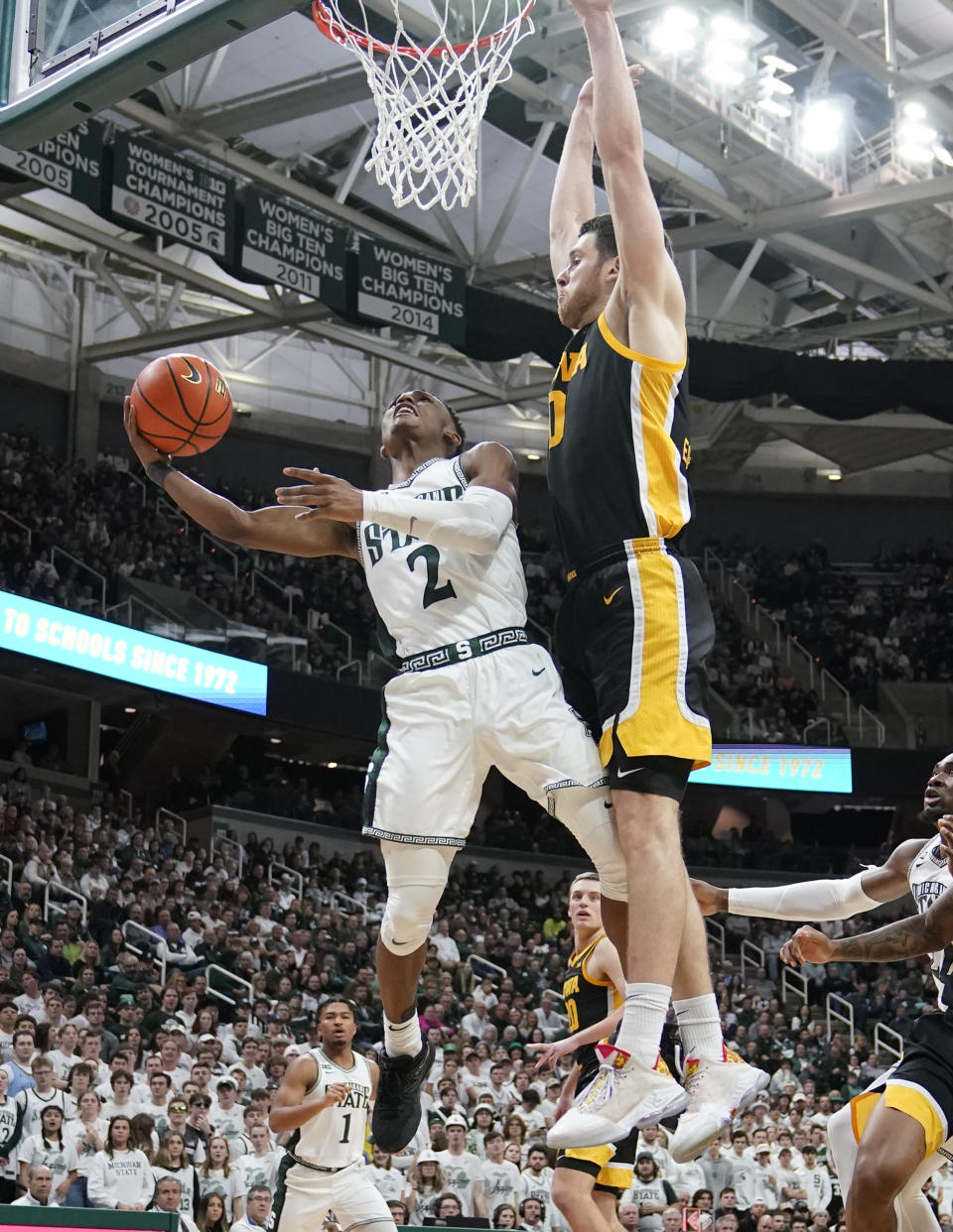 Michigan State guard Tyson Walker (2) attempts a basket as Iowa forward Filip Rebraca defends during the second half of an NCAA college basketball game, Thursday, Jan. 26, 2023, in East Lansing, Mich. (AP Photo/Carlos Osorio)