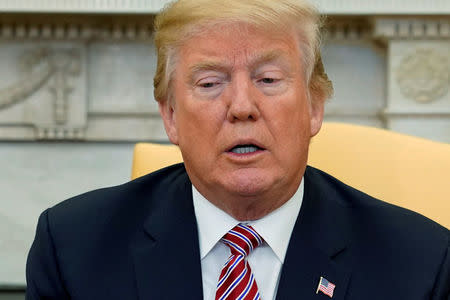 U.S. President Donald Trump pauses while speaking to reporters in the Oval Office at the White House in Washington, U.S., February 9, 2018. REUTERS/Jonathan Ernst