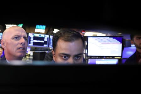 Traders work on the floor at the NYSE in New York