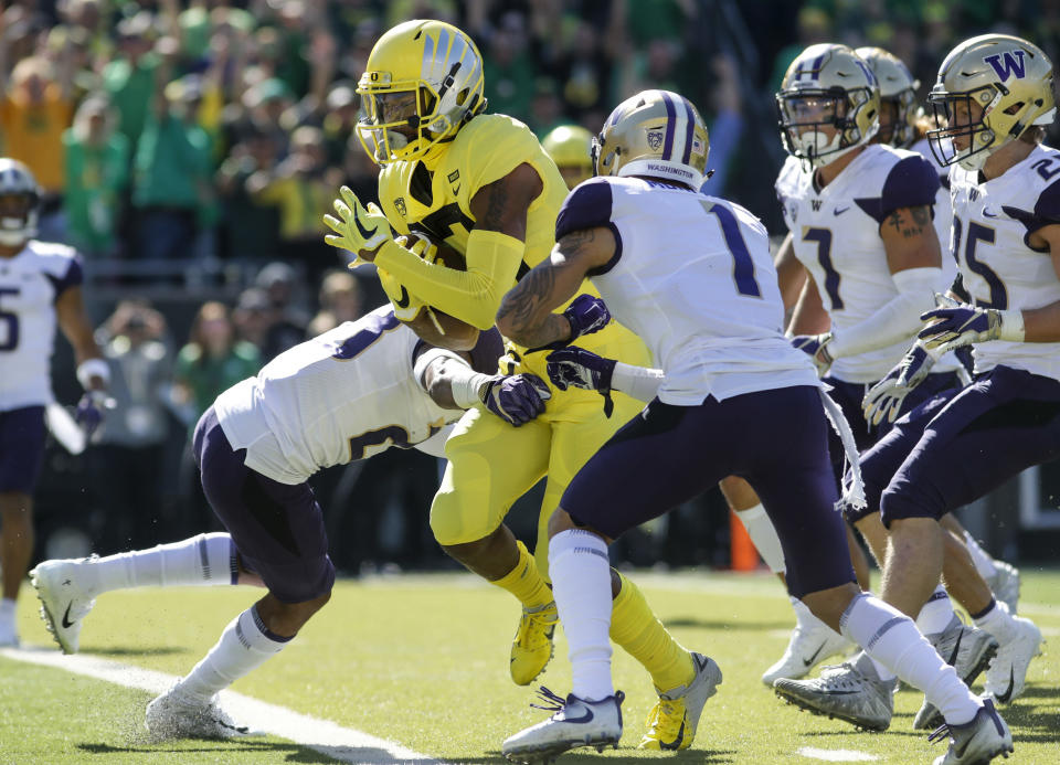 Oregon wide receiver Dillon Mitchell (13), crosses the goal line in the first quarter against Washington during an NCAA college football game in Eugene, Ore., Saturday, Oct. 13, 2018. (AP Photo/Thomas Boyd)