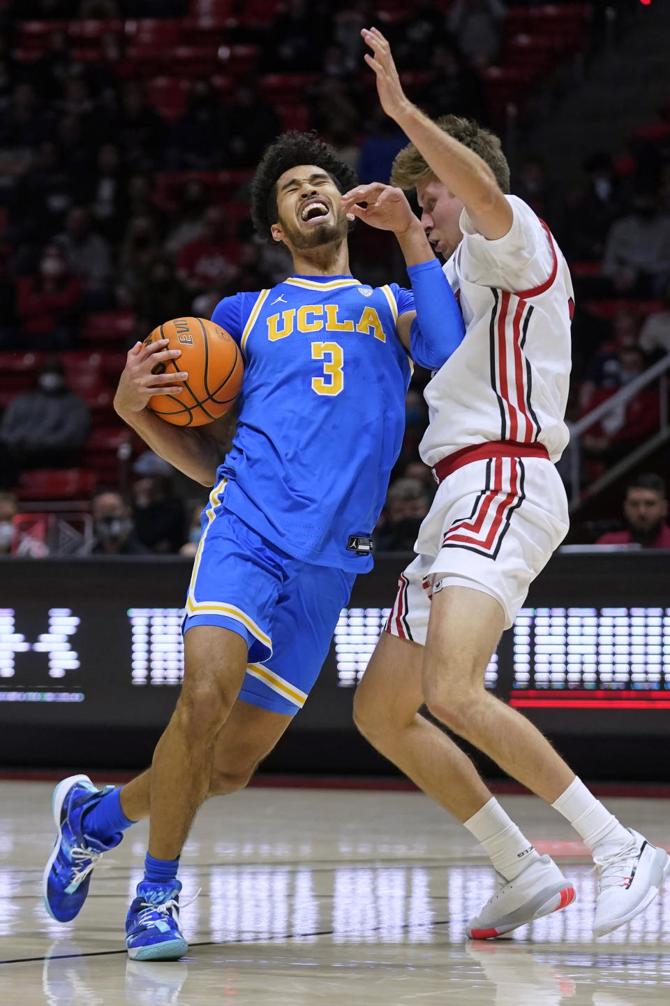 Utah guard Eli Ballstaedt, right, fouls UCLA guard Johnny Juzang (3) during the first half of an NCAA college basketball game Thursday, Jan. 20, 2022, in Salt Lake City. (AP Photo/Rick Bowmer)