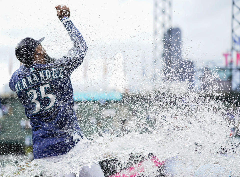 Seattle Mariners right fielder Teoscar Hernandez tries to avoid a dosing from Ty France after the Mariners' 5-4 win over the Oakland Athletics in a baseball game Wednesday, Aug. 30, 2023, in Seattle. (AP Photo/Lindsey Wasson)