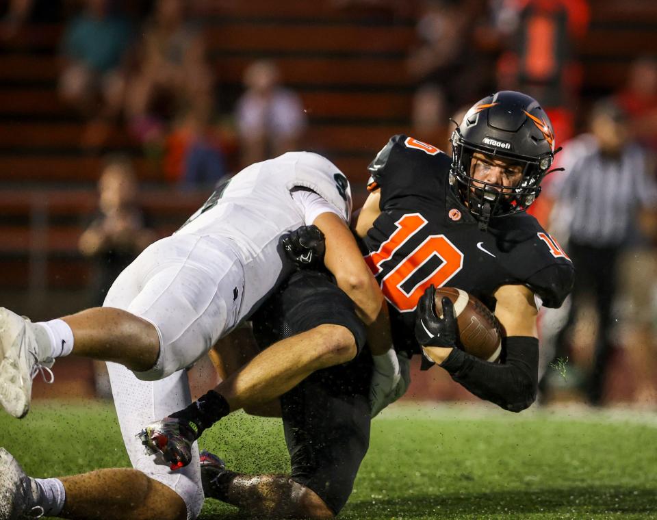 Sprague's Kenya Johnson (10) is brought down on the play by Sheldon's Will Haverland (9) during the game on Friday, Sept. 15, 2023 in Salem, Ore.