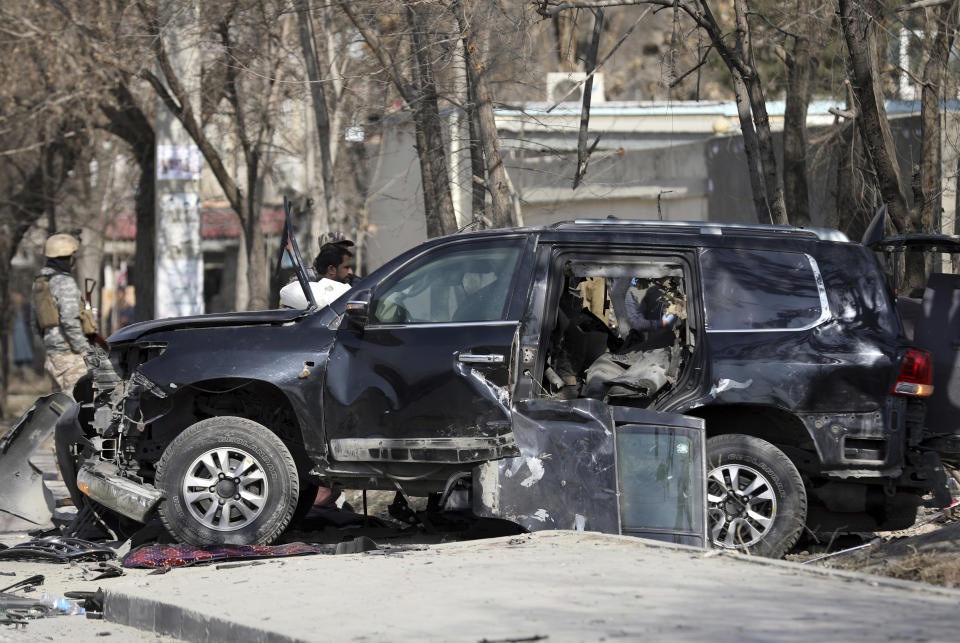 Afghan security personnel inspect the site of a deadly bomb attack in Kabul, Afghanistan, Tuesday, Feb. 9, 2021. A string of attacks on Tuesday in Afghanistan killed several government employees and several policemen. No one immediately claimed responsibility for the attacks. (AP Photo/Rahmat Gul)