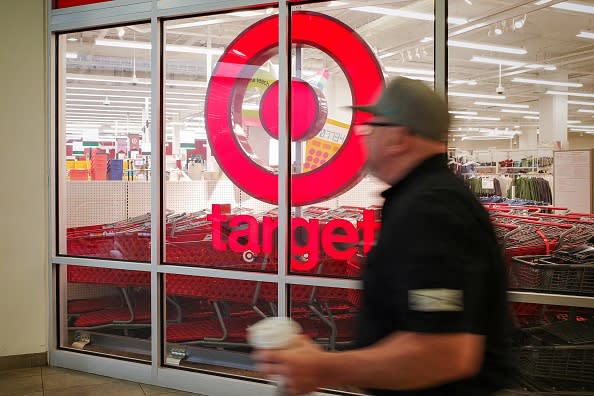 A shopper passes a sign for a Target store in the Tenleytown neighborhood of Washington, DC, on August 17, 2022. - US retail sales held steady in July as gas prices fell sharply, but the new data released Wednesday by the Commerce Department showed consumers are still spending, keeping the pressure on the Federal Reserve to continue its aggressive interest rate hikes. (Photo by MANDEL NGAN / AFP) (Photo by MANDEL NGAN/AFP via Getty Images)