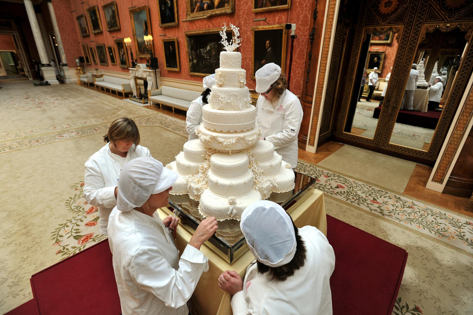 The team led by Fiona Cairns (not in picture) that made the Royal wedding cake, put on the finishing touches for Prince William and Kate Middleton, in the Picture Gallery of Buckingham Palace in central London on Friday April 29, 2011. (AP Photo/John Stillwell, Pool)