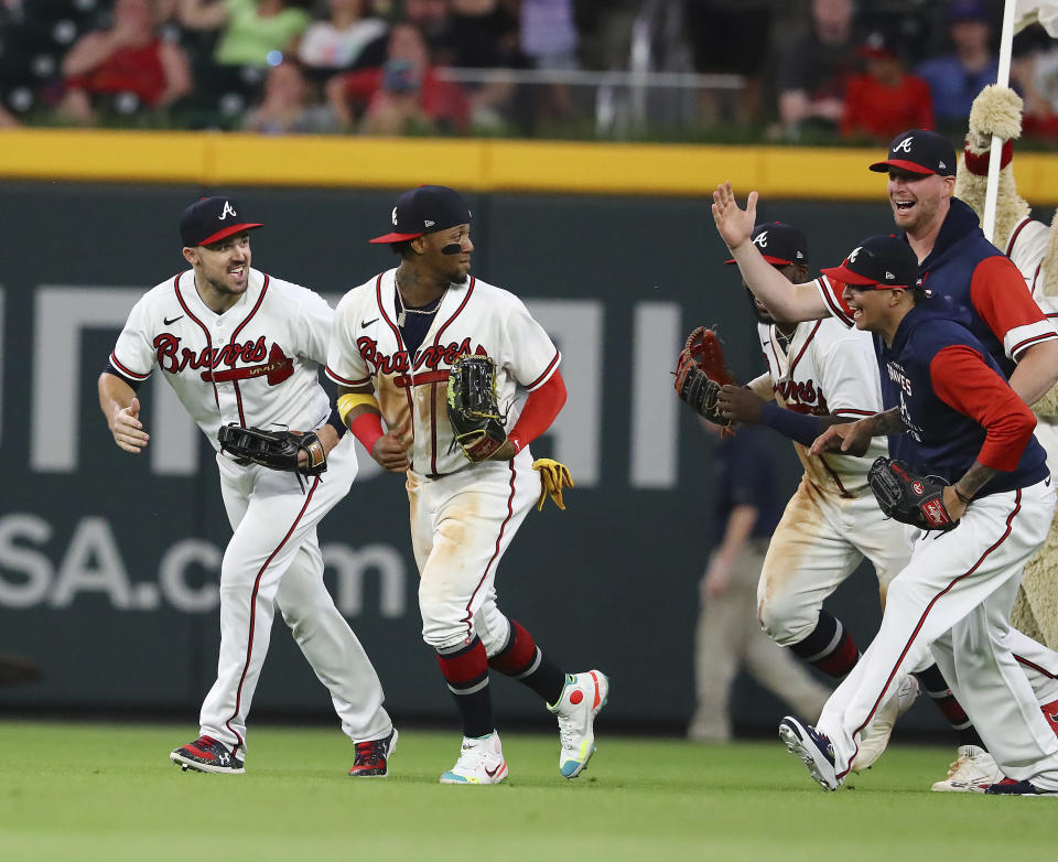 tlanta Braves outfielders Adam Duvall, Ronald Acuña and Michael Harris, from left, are pursued by the Braves' bullpen pitchers after the team's 7-1 win over the St. Louis Cardinals in a baseball game Tuesday, July 5, 2022, in Atlanta. (Curtis Compton/Atlanta Journal-Constitution via AP)