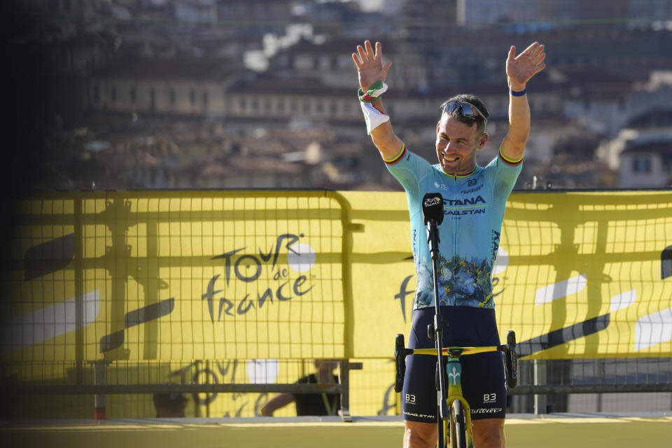 Britain's Mark Cavendish greets spectators during the team presentation in Florence, Italy, Thursday, June 27, 2024, two days before the start of the Tour de France cycling race. (AP Photo/Jerome Delay)