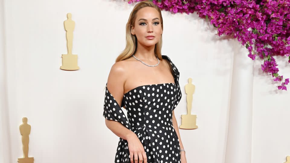 Jennifer Lawrence crossed the carpet in a retro polka-dot custom look by Christian Dior Haute Couture. Her Swarovski<strong> </strong>necklace and bracelet were made using lab-grown diamonds - Gilbert Flores/Variety/Getty Images