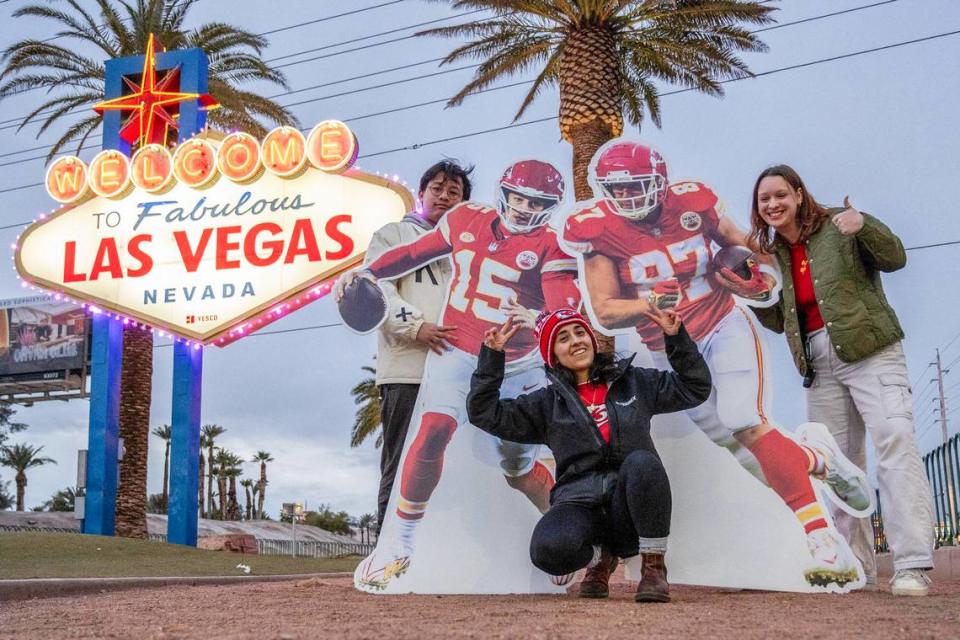 Kansas City Star journalists Irvin Zhang, left, Emily Curiel and Alison Booth pose for a photo in front of the Las Vegas welcome sign alongside life-size cutouts featuring Kansas City Chiefs quarterback Patrick Mahomes and tight end Travis Kelce. Emily Curiel/ecuriel@kcstar.com