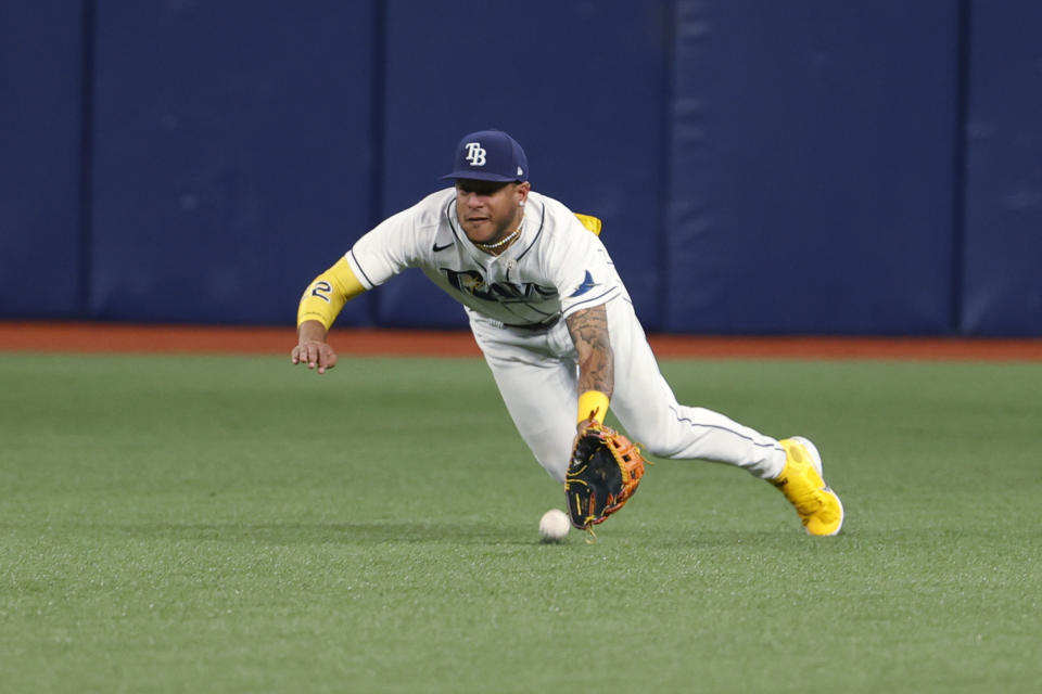 Tampa Bay Rays' Jose Siri dives for a fly ball hit by Texas Rangers' Jonah Heim, who singled during the sixth inning of a baseball game Friday, Sept. 16, 2022, in St. Petersburg, Fla. (AP Photo/Scott Audette)