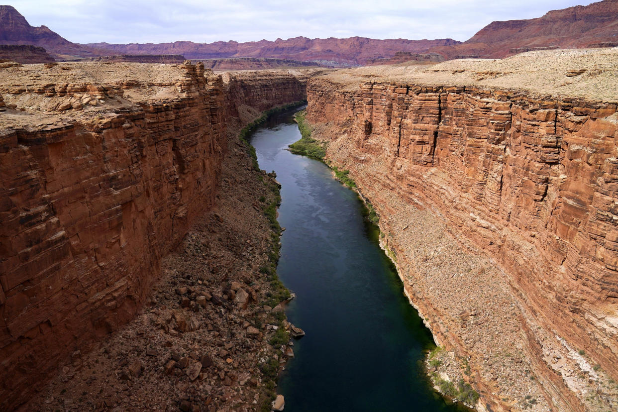 FILE - The Colorado River in the upper River Basin is pictured in Lees Ferry, Ariz., on May 29, 2021. The Supreme Court appears to be split in a dispute between the federal government and the Navajo Nation over water from the drought-stricken Colorado River. The high court heard arguments Monday, March 20, 2023, in a case that states argue could upend how water is shared in the Western U.S. if the court sides with the tribe. (AP Photo/Ross D. Franklin, File)