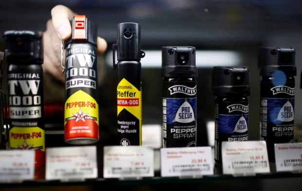 A file photo shows a row of pepper spray canisters in a gun shop in Germany. Alberta's request for the federal government to remove pepper spray from the list of prohibited weapons in the Criminal Code has been denied.  (Reuters - image credit)