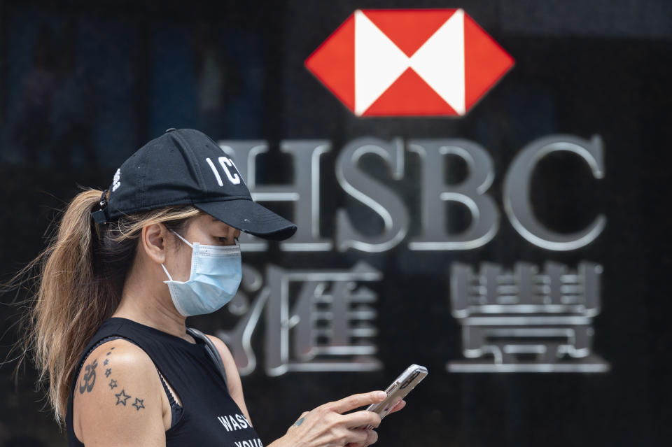 HONG KONG, CHINA - 2020/09/22: A woman wearing a mask stands in front of the British multinational banking and financial services holding company HSBC Bank seen in Hong Kong. (Photo by Miguel Candela/SOPA Images/LightRocket via Getty Images)