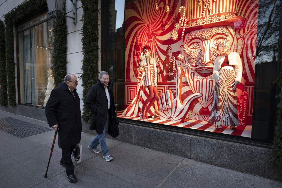 FILE - This Dec. 5, 2018 file photo shows men walking past a holiday window at the Bergdorf Goodman store, in New York. E. Jean Carroll, a New York-based advice columnist claims Donald Trump sexually assaulted her in a dressing room at a Manhattan department store in the mid-1990s. The first-person account was published Friday, June 21, in New York magazine. Trump denied the allegations and said “I’ve never met this person in my life.” (AP Photo/Mark Lennihan, File)