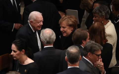 Former President Jimmy Carter, left, and Angela Merkel, Germany's chancellor - Credit: Bloomberg