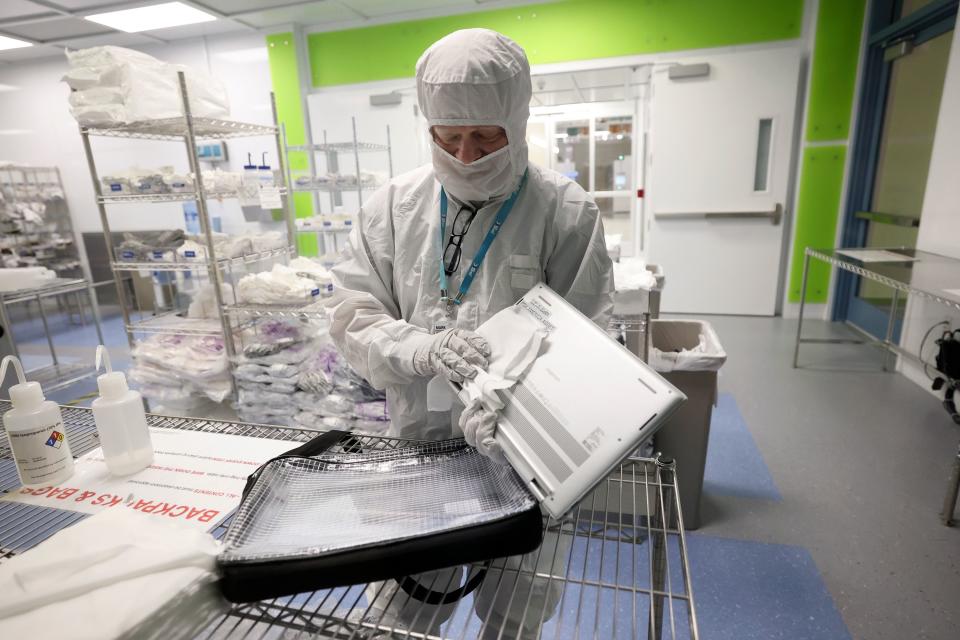 A employee cleans a computer and a bag in a gowning room at Texas Instruments in Lehi on Thursday, Nov. 2, 2023. | Kristin Murphy, Deseret News