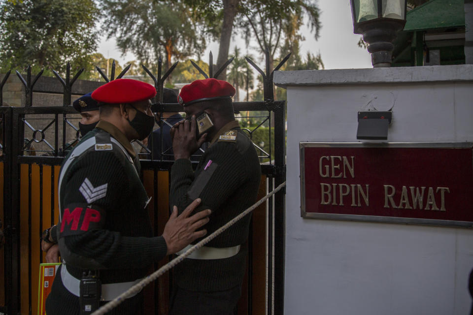 Military police personnel stand outside the residence of Chief of Defense Staff Bipin Rawat in New Delhi, India, Wednesday, Dec. 8, 2021. India’s military chief, Gen. Bipin Rawat, and 12 others were killed Wednesday in a helicopter crash in southern Tamil Nadu state, the air force said. (AP Photo/Altaf Qadri)