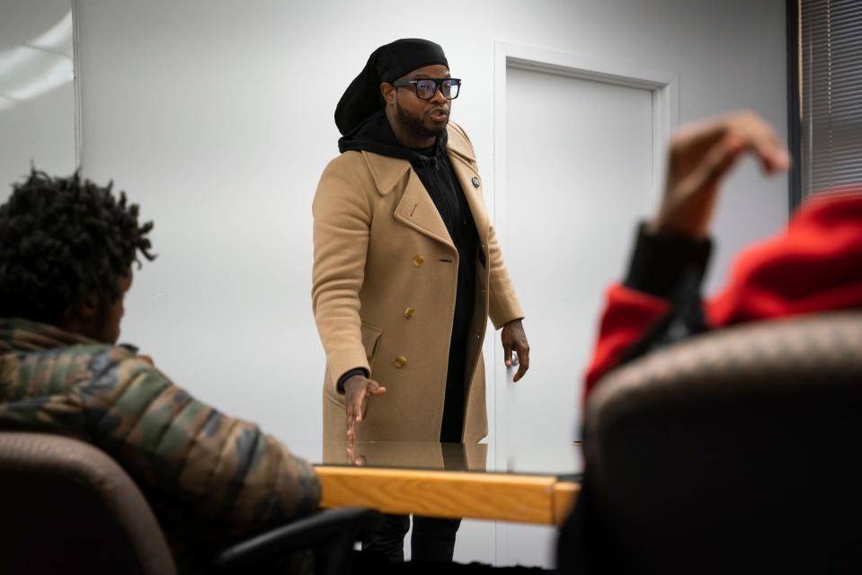 Dujuan "Zoe" Kennedy, community organizer with FORCE Detroit, discusses violence prevention and other life lessons with his mentees at The Block at Cass Park in Detroit on Wednesday, Oct. 19, 2022.