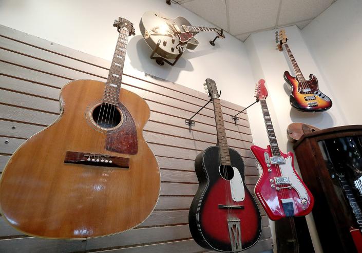Musical instruments hang on the walls of the new Johnny&#39;s Music Shop on the east side of Massillon. The shop recently opened at Oak Park Plaza.