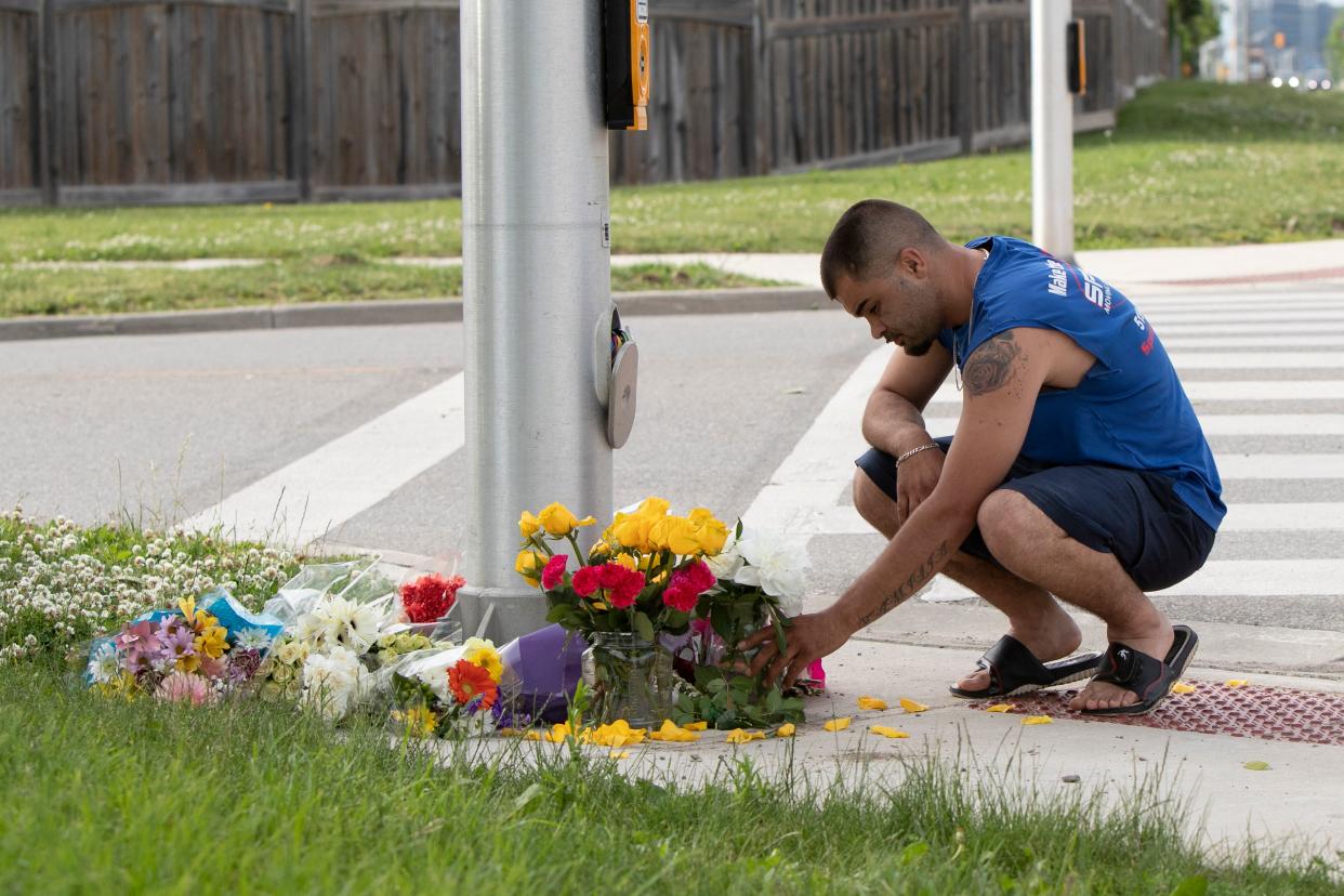 A man brings flowers and pays his respects at the scene where a man driving a pickup truck struck and killed four members of a Muslim family in London, Ontario, Canada on June 7, 2021. - A man driving a pick-up truck slammed into and killed four members of a Muslim family in the south of Canada's Ontario province, in what police said Monday was a 