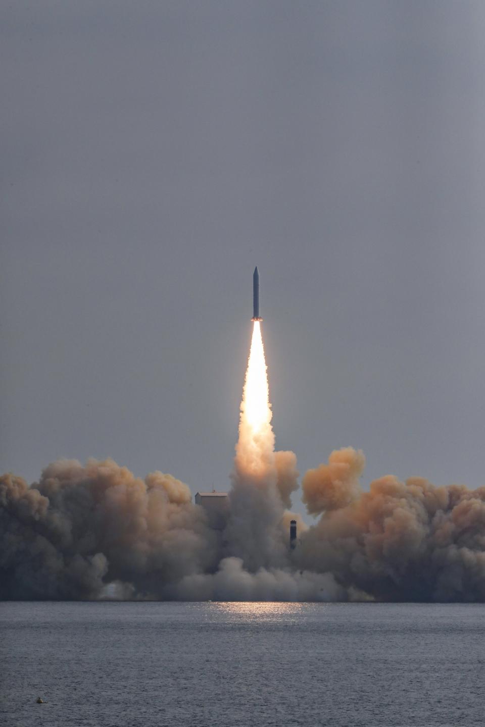 In this photo provided by South Korea Defense Ministry, the third test flight of solid-fuel space rocket is launched from a barge in waters near Jeju Island, South Korea, Monday, Dec. 4, 2023. (South Korea Defense Ministry via AP)