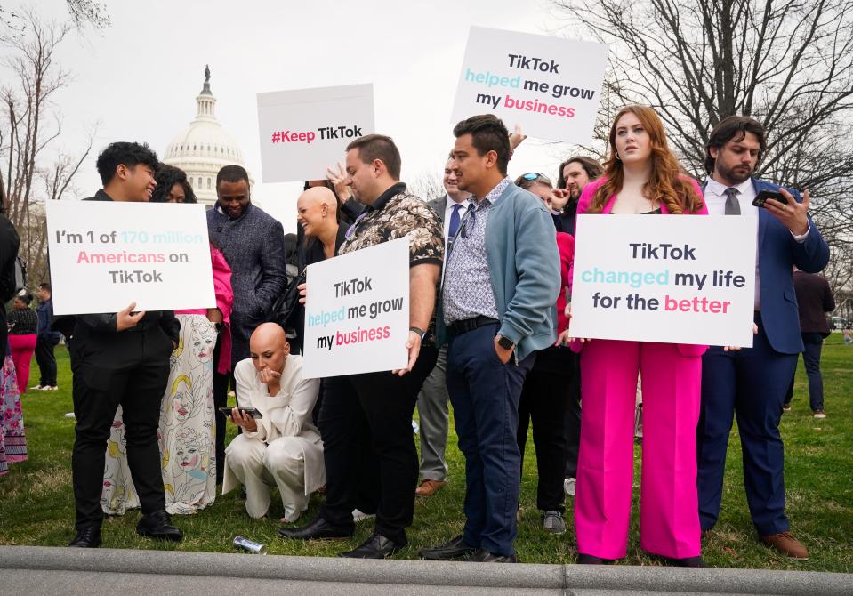 Pro-TikTok demonstrators outside the U.S. Capitol monitor the House vote on March 13, 2024.