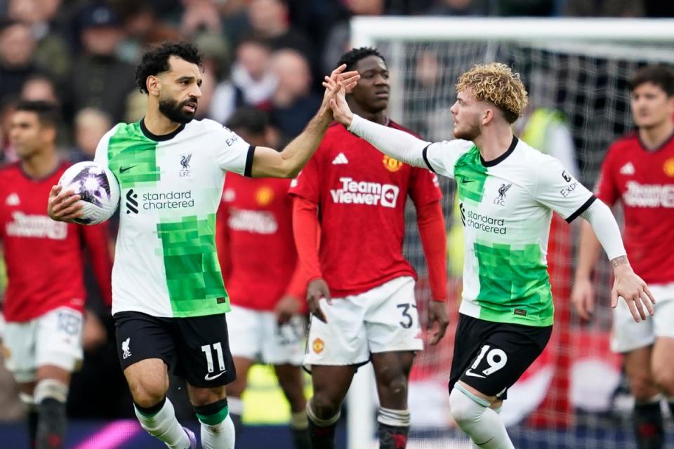 Liverpool's Mohamed Salah, left, celebrates with Harvey Elliott after scoring his side's second goal against Manchester United  (AP)