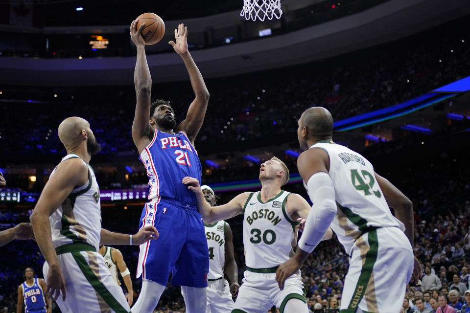 Philadelphia 76ers' Joel Embiid (21) goes up for a shot against Boston Celtics' Sam Hauser (30) during the first half of an NBA basketball game, Wednesday, Nov. 15, 2023, in Philadelphia. (AP Photo/Matt Slocum)