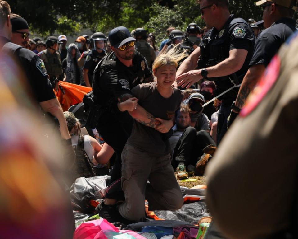 Police grab a protester as they break up an encampment on the University of Texas campus on April 29.<span class="copyright">Lorianne Willett for The Daily Texan</span>