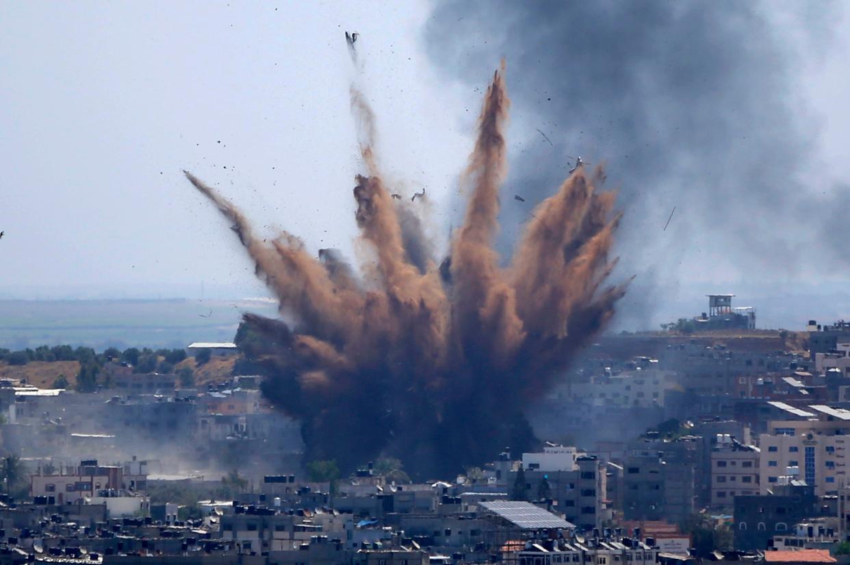 Smoke rises following Israeli airstrikes on a building in Gaza City on Thursday, May 13, 2021. Weary Palestinians are somberly marking the end of the Muslim holy month of Ramadan, as Hamas and Israel traded more rockets and airstrikes and Jewish-Arab violence raged across Israel.