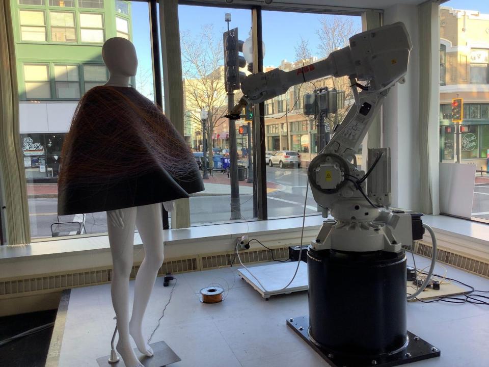 New Bedford Research and Robotics' "Splinter," the robotic arm, produces one of grad student Lilach Porgess' fashion designs at the Swain Studio in downtown New Bedford.