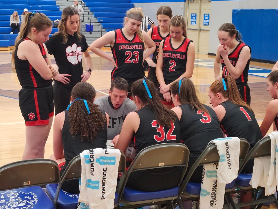 Circleville girls basketball coach Brian Bigam talks to his team during a timeout in the first half of a game at Washington Court House on Wednesday. The game was the Tigers' first since freshman center Addison Edgington was injured in a car crash Friday night. Bigam's shirt reads "LEFTY" in Edgington's honor.