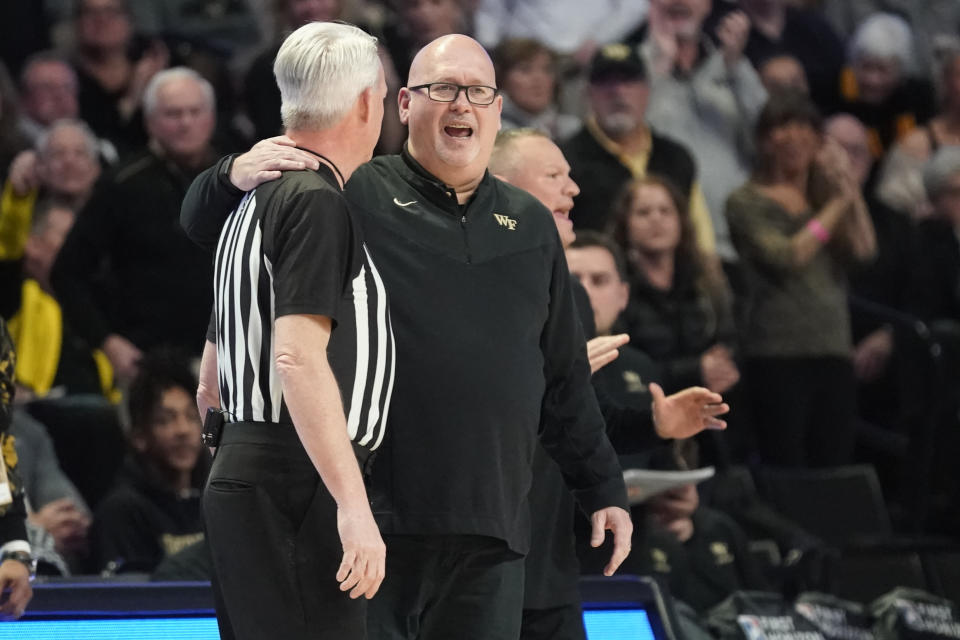 Wake Forest head coach Steve Forbes, right, speaks to an official during the first half of an NCAA college basketball game against North Carolina in Winston-Salem, N.C., Tuesday, Feb. 7, 2023. (AP Photo/Chuck Burton)