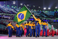 <p>Flag bearer Edson Bindilatti of Brazil and teammates enter the stadium wearing yellow-and-blue color-block puffer jackets and pants during the opening ceremony of the 2018 PyeongChang Games. (Photo: Matthias Hangst/Getty Images) </p>