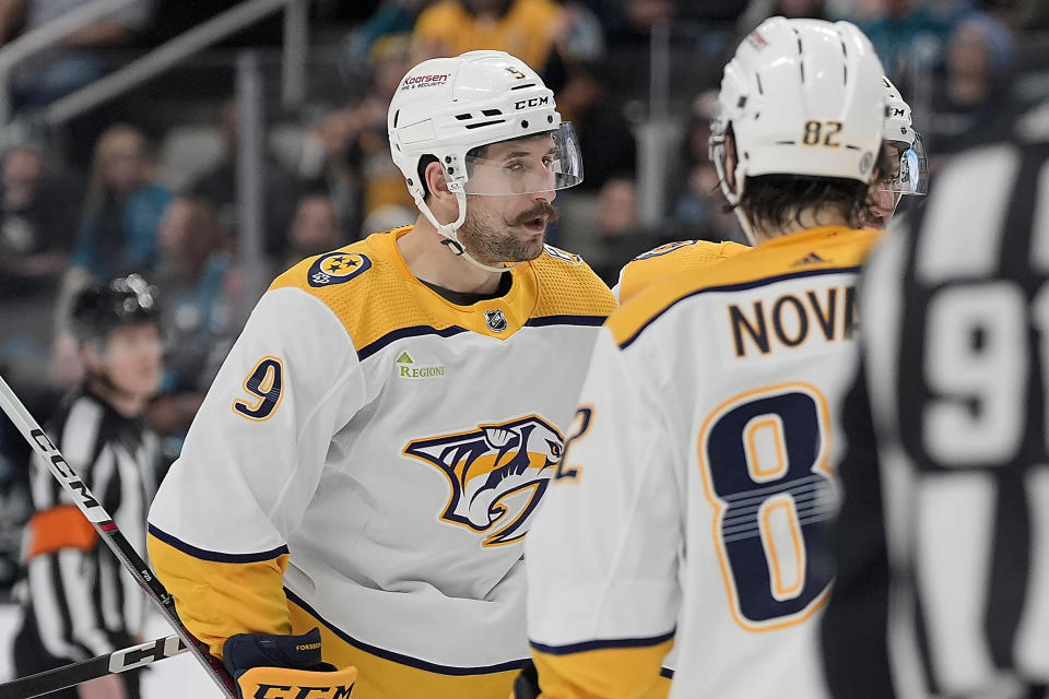 Nashville Predators left wing Filip Forsberg (9) is congratulated by Tommy Novak (82) after scoring a goal against the San Jose Sharks during the second period of an NHL hockey game Saturday, Feb. 24, 2024, in San Jose, Calif. (AP Photo/Tony Avelar)