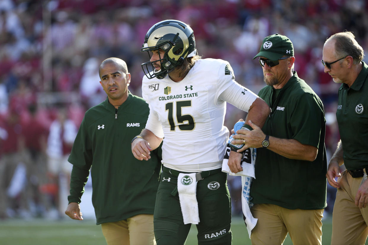 Colorado State quarterback Collin Hill is helped off the field after being injured against Arkansas during an NCAA football game on Saturday, Sept. 14, 2019 in Fayetteville, Ark. (AP Photo/Michael Woods)