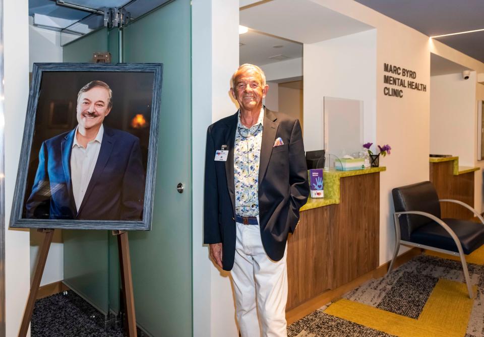 Donor Al Jones stands by a photo of his late husband, Marc Byrd, at the May 4, 2022, ribbon-cutting ceremony of Byrd's eponymous mental health clinic at DAP Health in Palm Springs.
