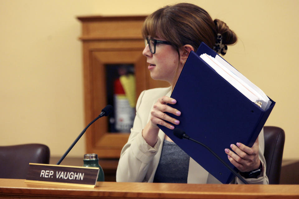 Kansas state Rep. Lindsay Vaughn, D-Overland Park, holds up a binder of printed testimony in favor of expanding the state's Medicaid program during a House Health and Human Services Committee debate, Thursday, March 21, 2024, at the Statehouse in Topeka, Kan. In committee votes, Republican lawmakers in Kansas and Georgia have blocked Medicaid expansion plans. (AP Photo/John Hanna)