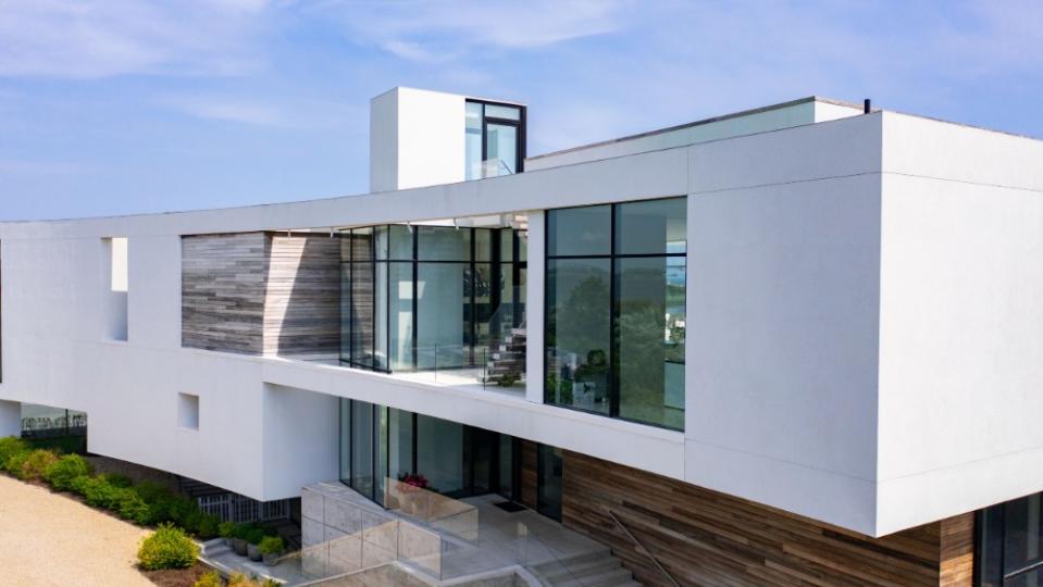 The modern home has a sleek curved exterior. - Credit: The Corcoran Group