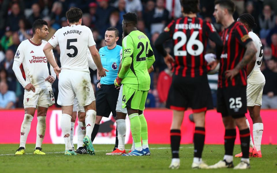 The players wait to find out whether Bournemouth have been awarded a penalty.