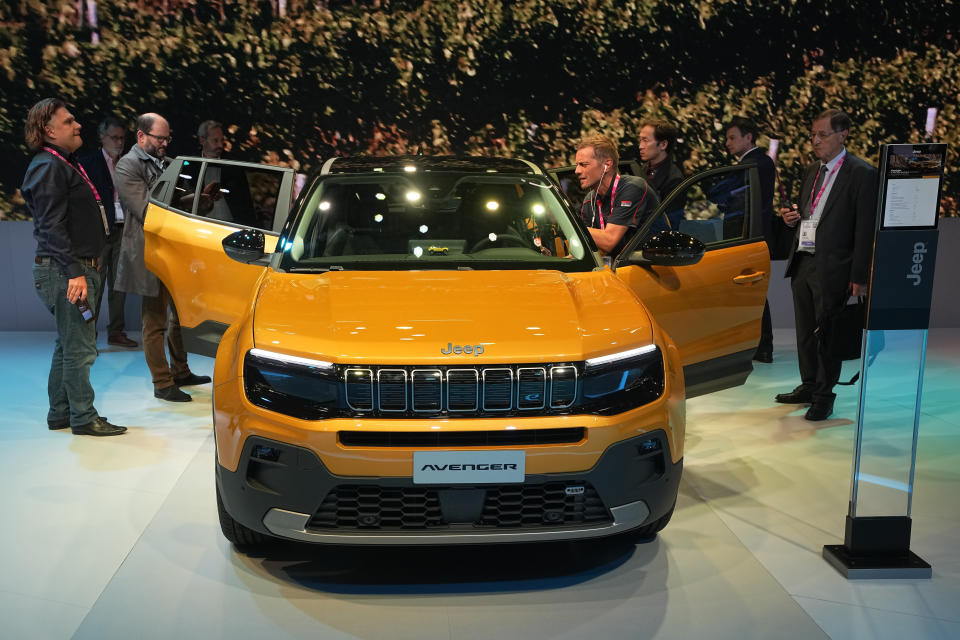 People gather around the electric-powered Jeep Avenger SUV at the Paris Car Show Monday, Oct. 17, 2022 in Paris. Europe is leading the charge into electric vehicles as battery powered cars break out of their niche market of first adopters and enter the mainstream with increasing market share that's forecast to grow strongly as the EU pushes to phase out internal combustion engine vehicles by 2035 (AP Photo/Michel Euler)