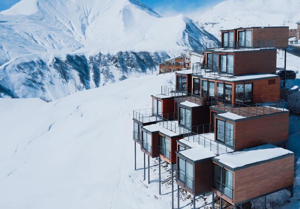 <p>The Quadrum Ski & Yoga Resort in Gudauri, Georgia, features stacked shipping containers clad in wood paneling, creating a modernist ski lodge that contrasts greatly with the Caucasus Mountains backdrop.</p>