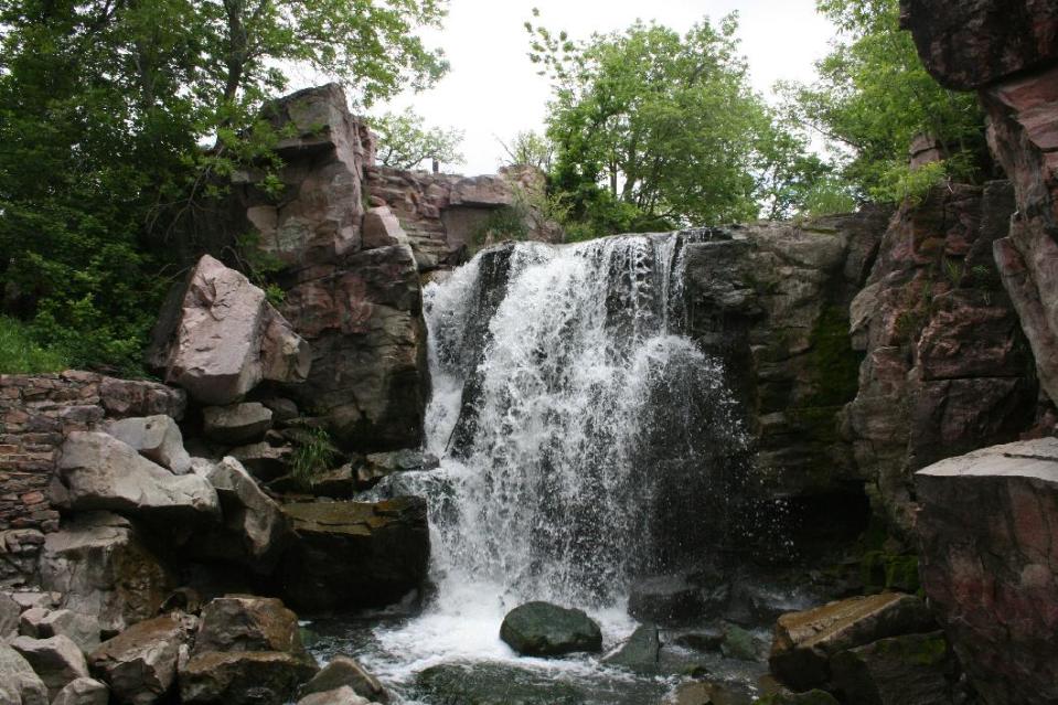 This June 5, 2013 photo shows the Winnewissa Falls at Pipestone National Monument in Minnesota. More than 50 Native Americans travel to Pipestone to quarry catlinite _ sheets of stone _ that will then be carved into pipes used in traditional ceremonies. For visitors, the site offers a museum and trail that includes the waterfall. (AP Photos/Kristi Eaton)