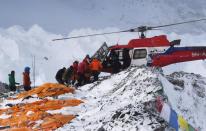 An injured person is loaded onto a rescue helicopter at Everest Base Camp, on April 26, 2015