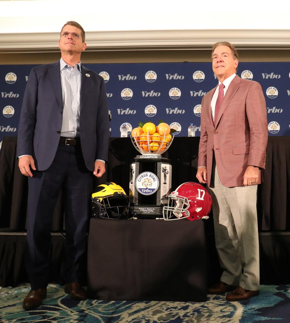 Michigan head coach Jim Harbaugh and Alabama head coach Nick Saban pose with the Citrus Bowl trophy Tuesday, December 31, 2019 at the Rosen Plaza Hotel in Orlando, Fl.